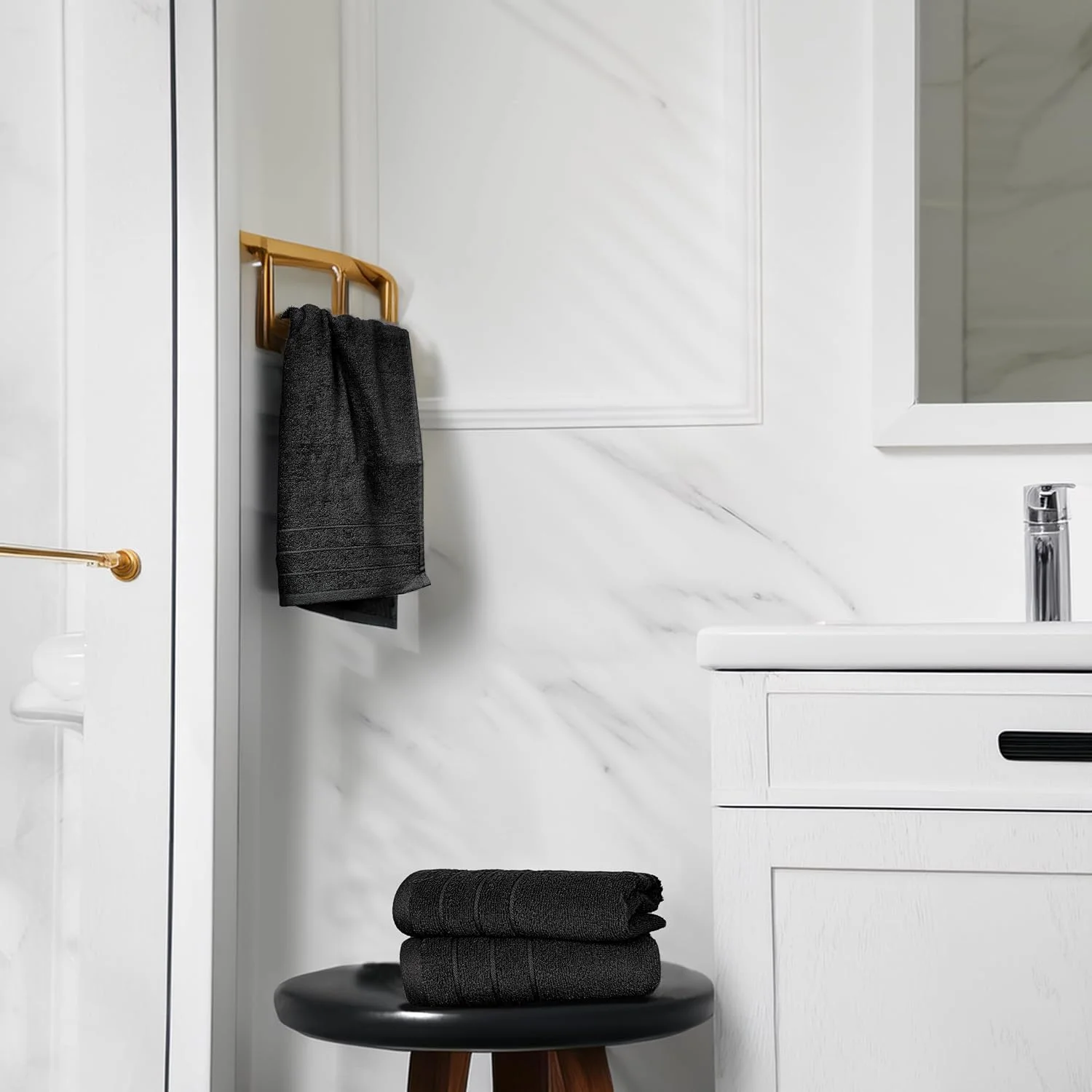 Black Tens Towels hanging from a brass rail