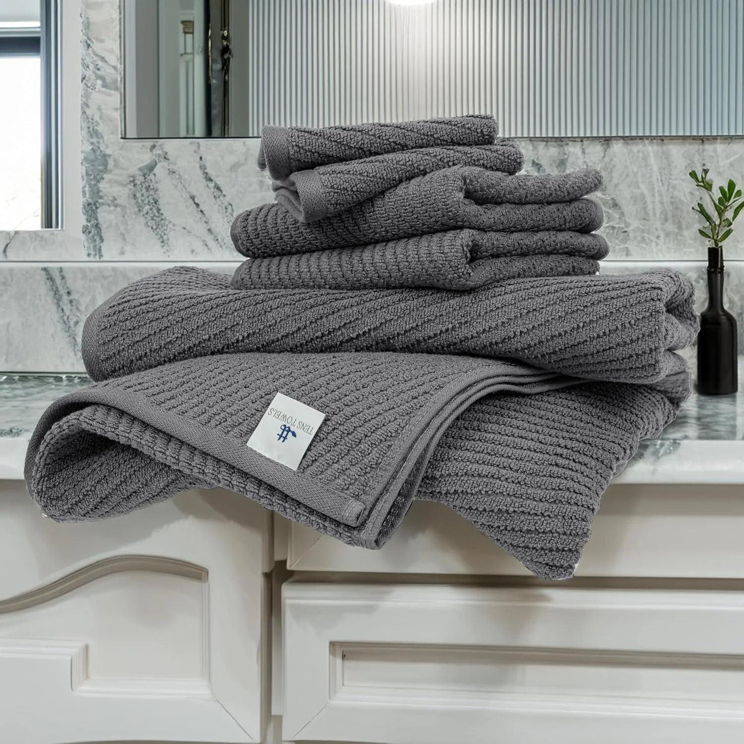 Dark grey zero twist towels folded on a counter